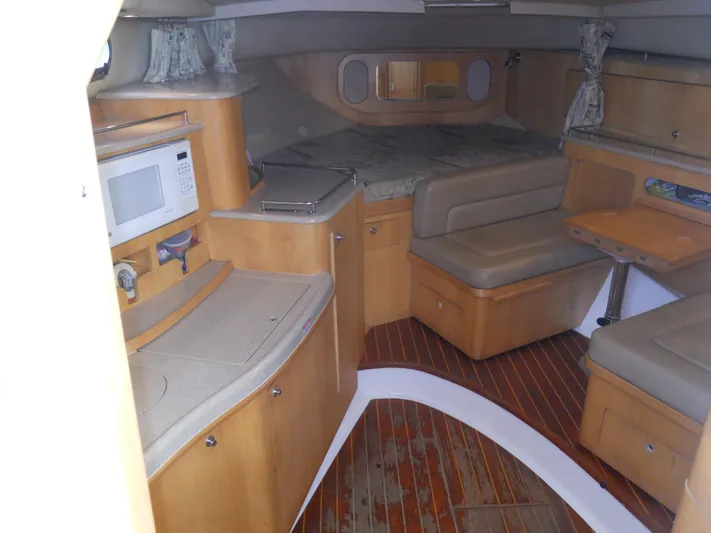 Fish Tales Yacht Photos Pics Interior of 2000 Boston Whaler 34 Defiance boat with kitchenette and seating area.