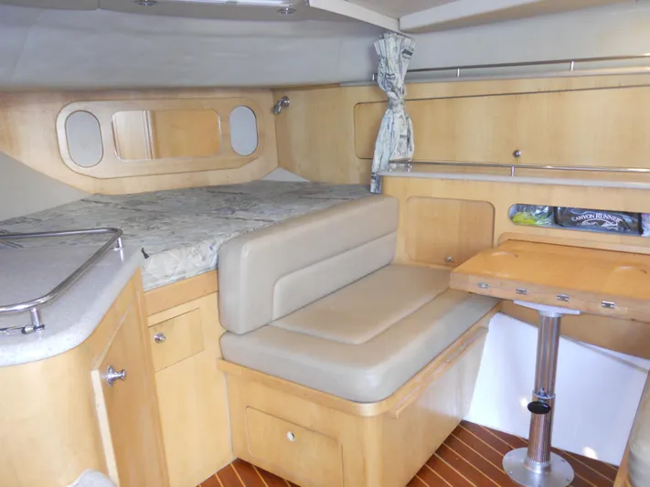 Fish Tales Yacht Photos Pics Interior of 2000 Boston Whaler 34 Defiance boat with seating and table.