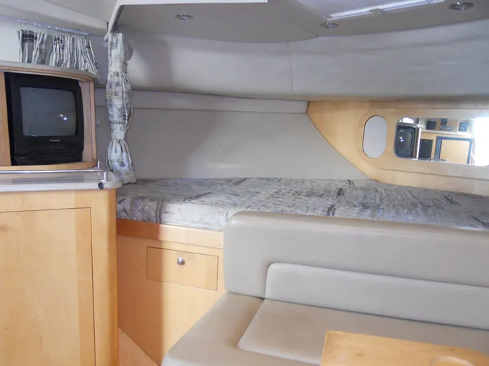 Fish Tales Yacht Photos Pics Interior of 2000 Boston Whaler 34 Defiance, featuring cozy cabin with bed and TV.