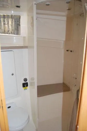 Fish Tales Yacht Photos Pics Bathroom interior of 2000 Boston Whaler 34 Defiance boat, featuring shower and toilet.