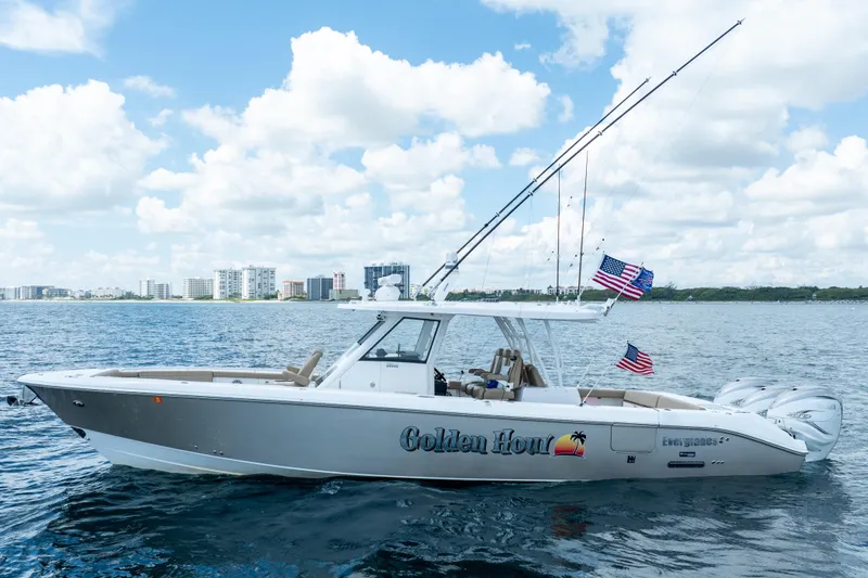 Golden Hour Yacht Photos Pics 2021 Everglades 395 Center Console boat on water, city skyline in background.