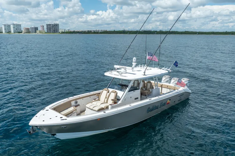 Golden Hour Yacht Photos Pics 2021 Everglades 395 Center Console boat on open water, with city skyline in background.