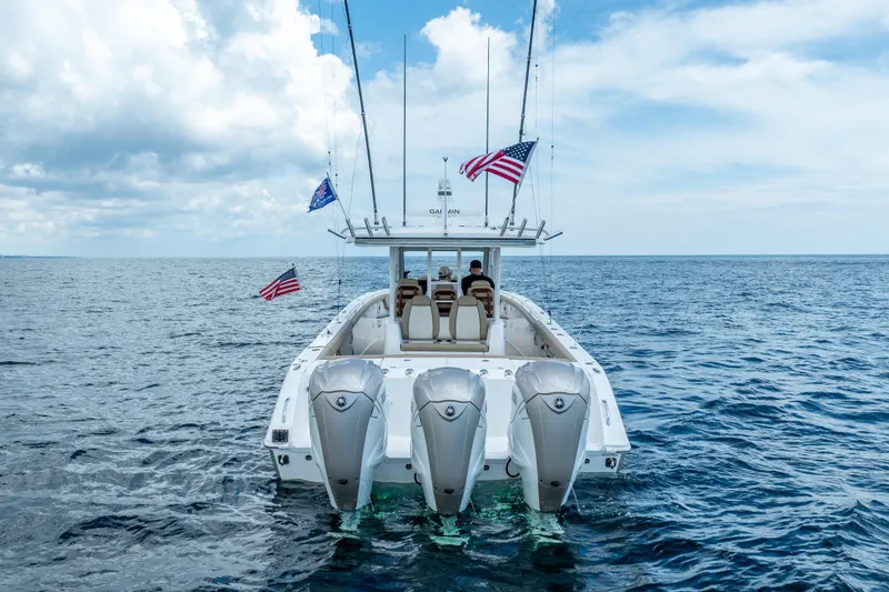 Golden Hour Yacht Photos Pics 2021 Everglades 395 Center Console boat on open sea with American flags.