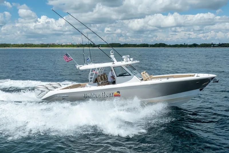 Golden Hour Yacht Photos Pics 2021 Everglades 395 Center Console boat cruising on open water under a cloudy sky.