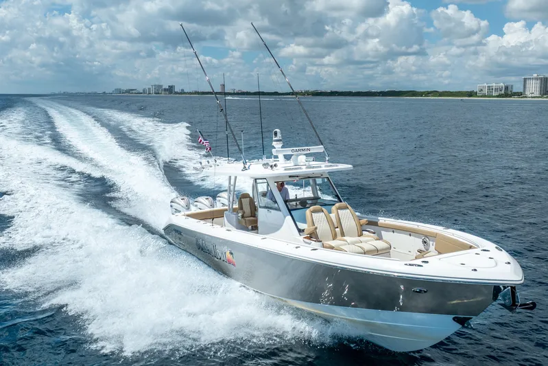 Golden Hour Yacht Photos Pics 2021 Everglades 395 Center Console boat cruising on open water under a cloudy sky.