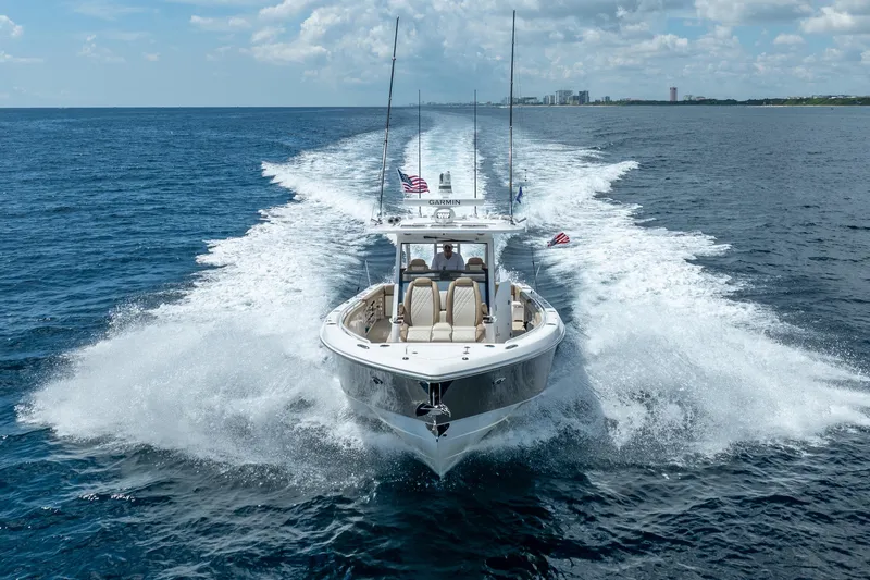 Golden Hour Yacht Photos Pics 2021 Everglades 395 Center Console boat cruising on open ocean under clear skies.