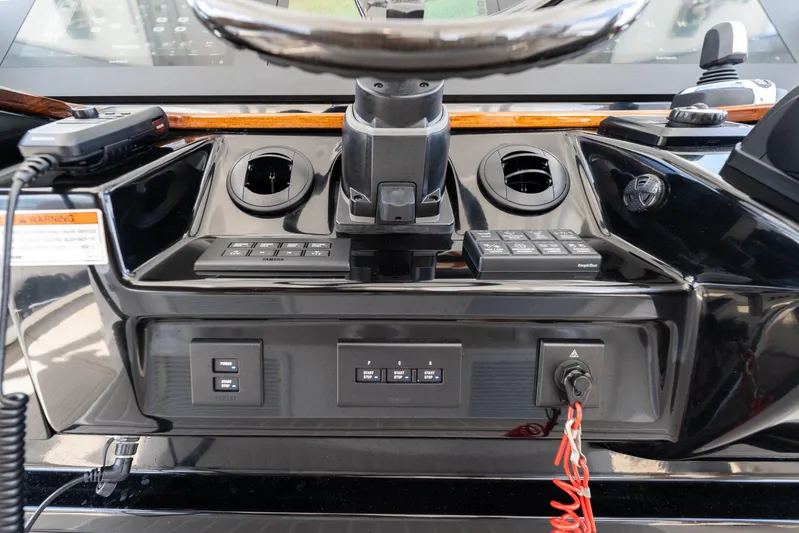 Golden Hour Yacht Photos Pics 2021 Everglades 395 Center Console dashboard with controls and steering wheel.