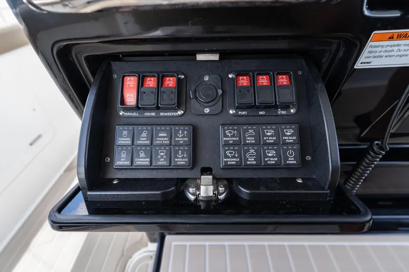Golden Hour Yacht Photos Pics Control panel of 2021 Everglades 395 Center Console boat with various switches and buttons.