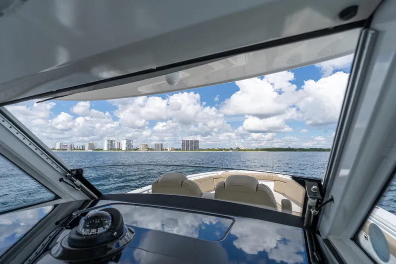 Golden Hour Yacht Photos Pics View from 2021 Everglades 395 Center Console boat, overlooking ocean and city skyline.