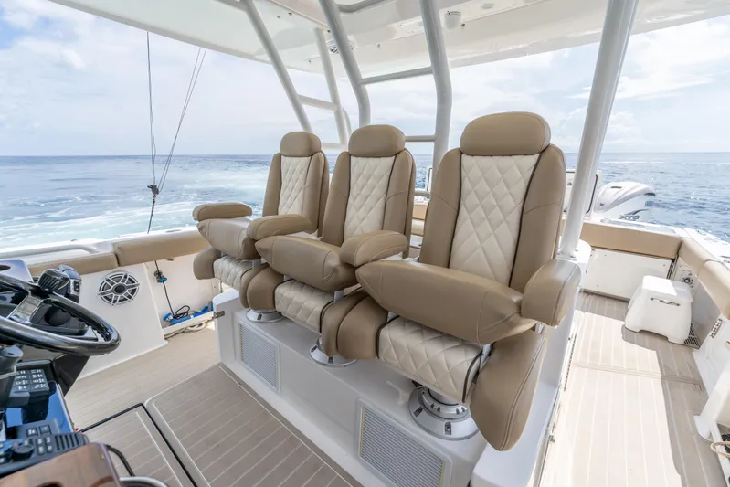 Golden Hour Yacht Photos Pics Luxurious seating on 2021 Everglades 395 Center Console boat, ocean view in background.