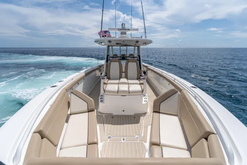 Golden Hour Yacht Photos Pics 2021 Everglades 395 Center Console boat on open ocean, featuring spacious seating and modern design.