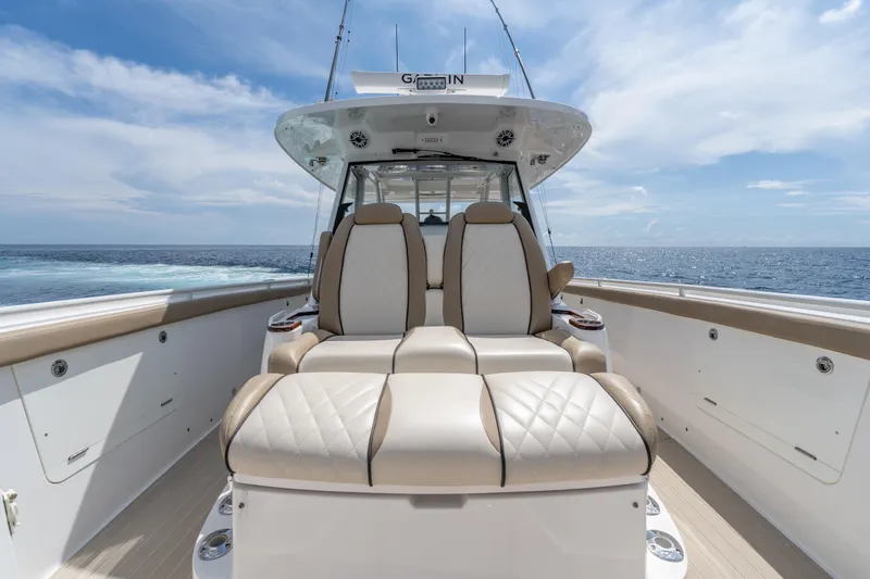 Golden Hour Yacht Photos Pics 2021 Everglades 395 Center Console boat with luxurious seating, ocean view, and clear sky.