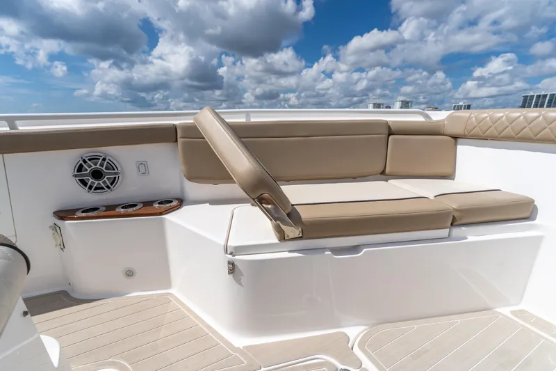 Golden Hour Yacht Photos Pics Luxurious seating on 2021 Everglades 395 Center Console boat under a vibrant sky.