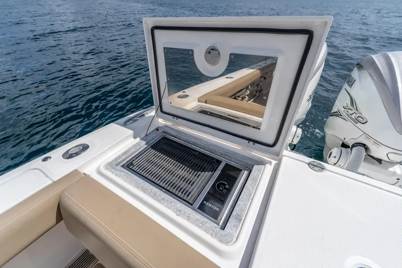 Golden Hour Yacht Photos Pics 2021 Everglades 395 Center Console boat with Kenyon grill, open hatch, and Yamaha engine.