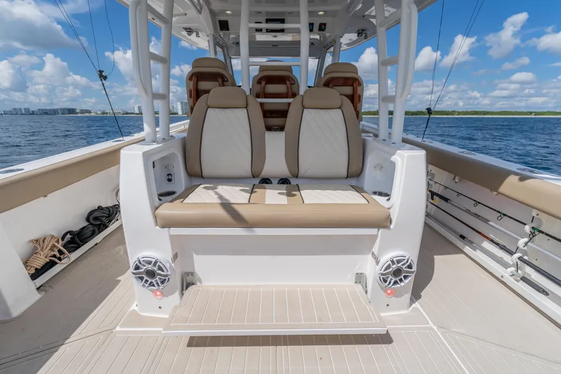 Golden Hour Yacht Photos Pics 2021 Everglades 395 Center Console boat interior with seating, ocean view, and clear sky.