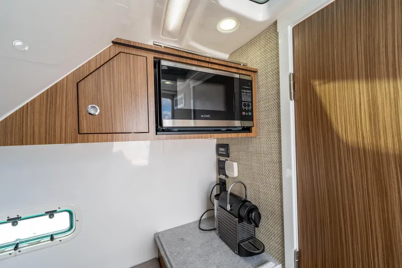 Golden Hour Yacht Photos Pics Interior of 2021 Everglades 395 Center Console with microwave and coffee maker.