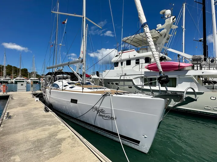 Mystic Impression Yacht Photos Pics 2022 Elan Impression 50.1 yacht docked at marina under clear blue sky.
