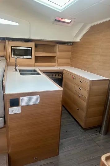 Mystic Impression Yacht Photos Pics Modern kitchen interior of 2022 Elan Impression 50.1 yacht with wood finish.