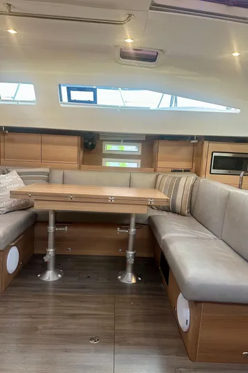 Mystic Impression Yacht Photos Pics 2022 Elan Impression 50.1 yacht interior with modern seating and wooden table.