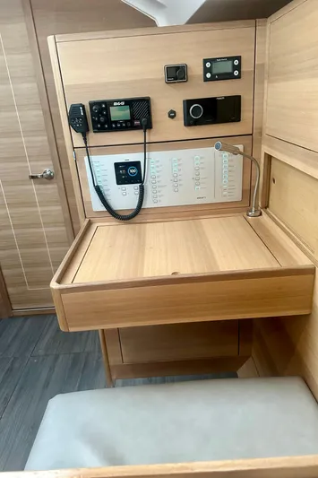 Mystic Impression Yacht Photos Pics 2022 Elan Impression 50.1 yacht interior with navigation equipment and wooden desk.