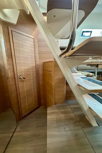 Mystic Impression Yacht Photos Pics Interior of 2022 Elan Impression 50.1 yacht, featuring wooden stairs and door.