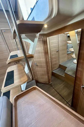 Mystic Impression Yacht Photos Pics Interior of 2022 Elan Impression 50.1 yacht, featuring modern wooden design and sleek staircase.