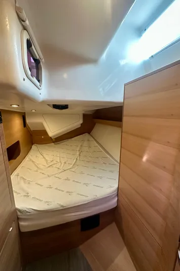 Mystic Impression Yacht Photos Pics 2022 Elan Impression 50.1 yacht cabin with wooden interior and cozy bed.