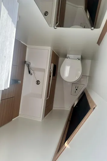 Mystic Impression Yacht Photos Pics 2022 Elan Impression 50.1 yacht bathroom with modern fixtures and wooden accents.