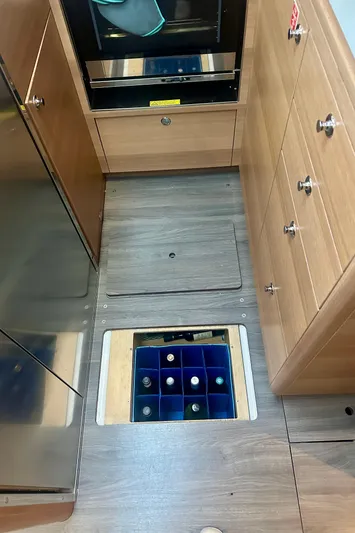 Mystic Impression Yacht Photos Pics 2022 Elan Impression 50.1 yacht interior with floor storage for wine bottles.