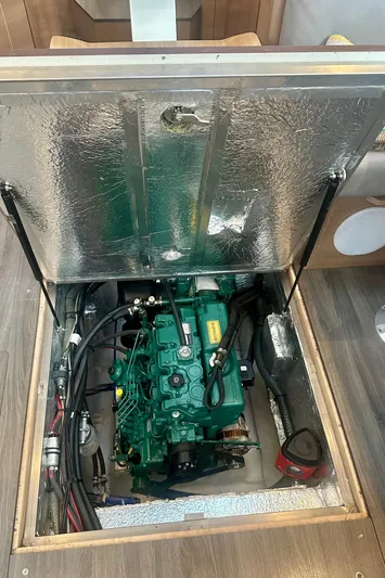 Mystic Impression Yacht Photos Pics Engine compartment of a 2022 Elan Impression 50.1 sailboat, showcasing the engine and surrounding components.