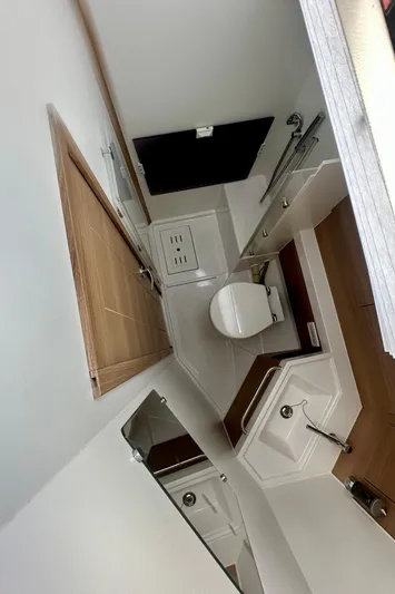 Mystic Impression Yacht Photos Pics 2022 Elan Impression 50.1 yacht bathroom with modern fixtures and wooden accents.