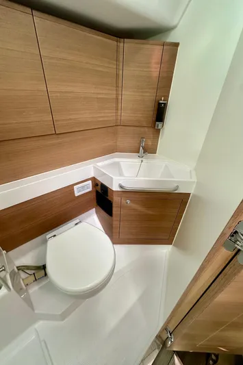 Mystic Impression Yacht Photos Pics 2022 Elan Impression 50.1 yacht bathroom with modern wood cabinetry and compact design.