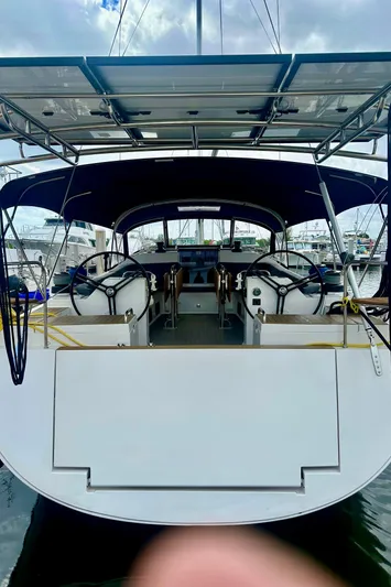 Mystic Impression Yacht Photos Pics 2022 Elan Impression 50.1 yacht with dual steering wheels, docked at a marina.