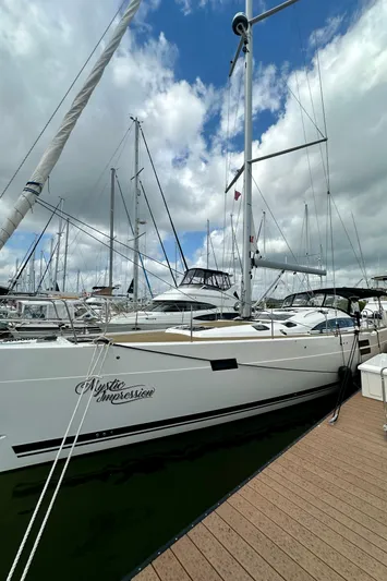 Mystic Impression Yacht Photos Pics 2022 Elan Impression 50.1 yacht docked at marina under cloudy sky.