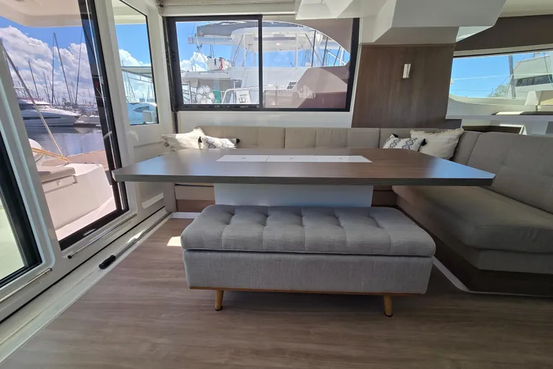 Wiley Pixie Yacht Photos Pics Modern interior of 2023 Bali CATSPACE yacht with spacious seating and table.