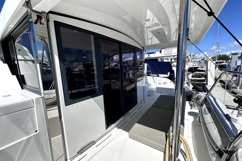 Wiley Pixie Yacht Photos Pics 2023 Bali CATSPACE yacht deck with seating, sliding doors, and marina view.
