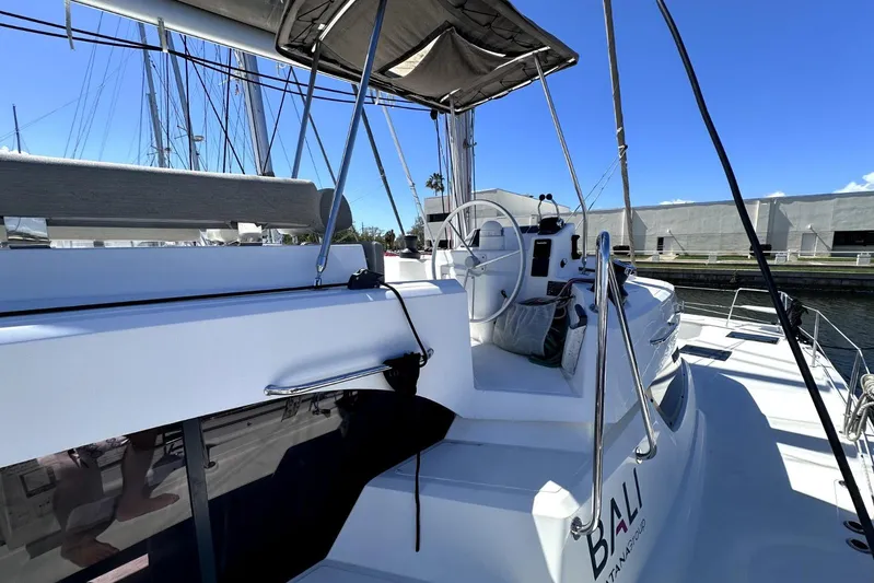 Wiley Pixie Yacht Photos Pics 2023 Bali CATSPACE yacht helm with canopy, docked under clear blue sky.
