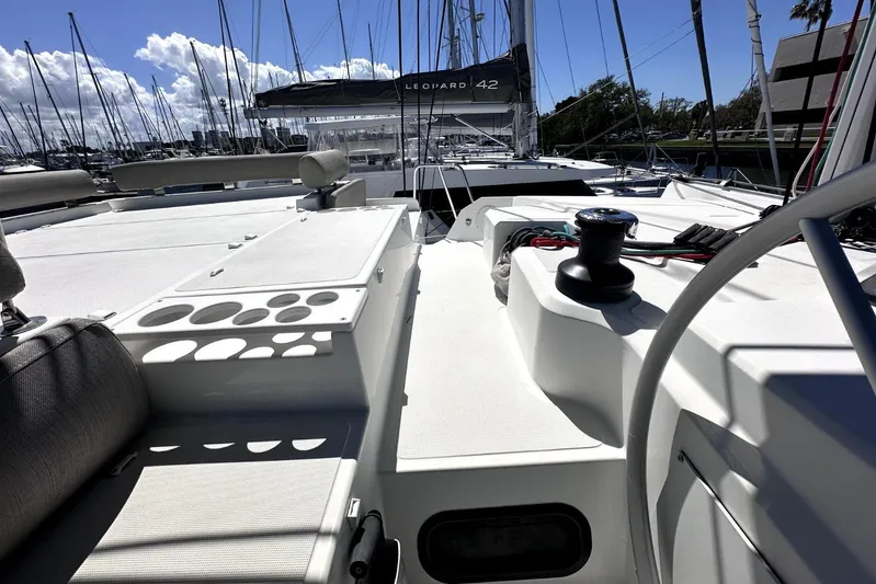 Wiley Pixie Yacht Photos Pics 2023 Bali CATSPACE catamaran deck with winch, docked in a marina under a sunny sky.
