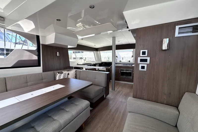 Wiley Pixie Yacht Photos Pics Luxurious interior of 2023 Bali CATSPACE catamaran with modern seating and kitchen area.