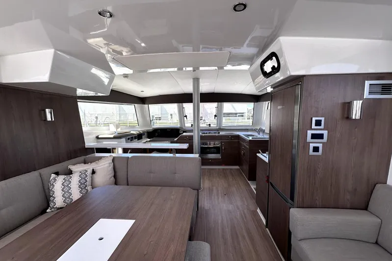 Wiley Pixie Yacht Photos Pics Luxurious interior of 2023 Bali CATSPACE catamaran with modern kitchen and seating area.