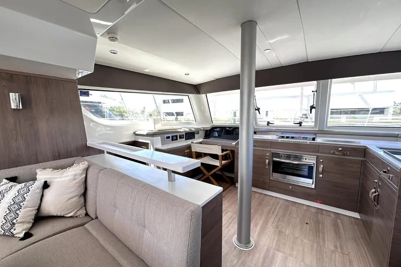 Wiley Pixie Yacht Photos Pics Modern interior of 2023 Bali CATSPACE catamaran with kitchen and seating area.