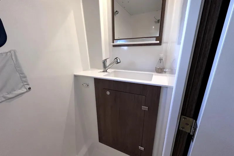 Wiley Pixie Yacht Photos Pics Modern bathroom sink area in 2023 Bali CATSPACE yacht, featuring sleek design and wooden cabinetry.