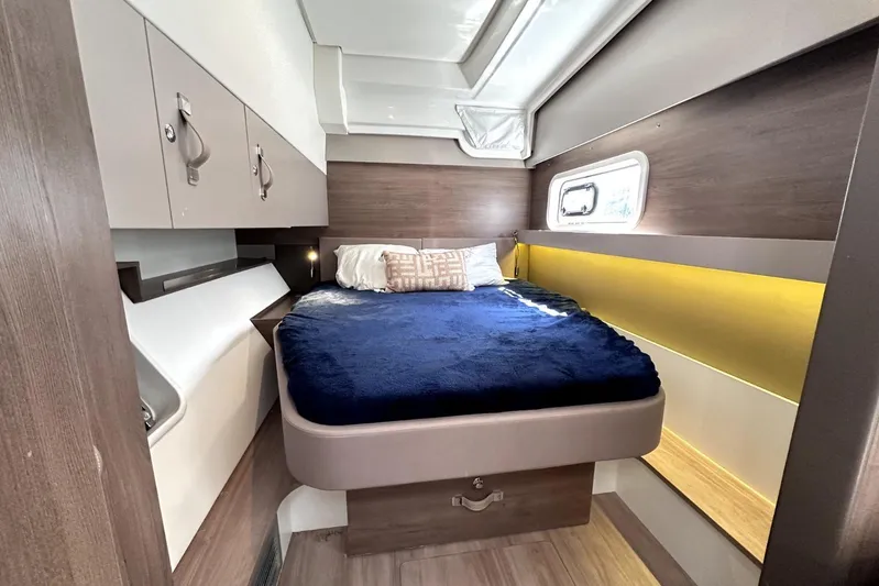Wiley Pixie Yacht Photos Pics 2023 Bali CATSPACE cabin with cozy bed, modern design, and ample storage.