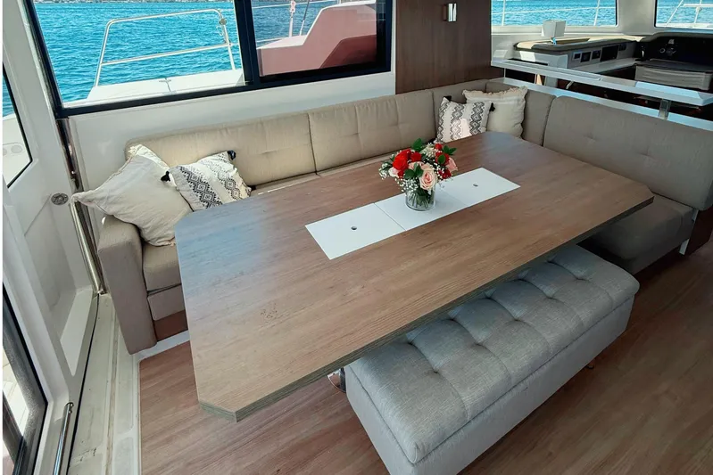 Wiley Pixie Yacht Photos Pics Luxurious interior of 2023 Bali CATSPACE yacht with elegant dining area and sea view.
