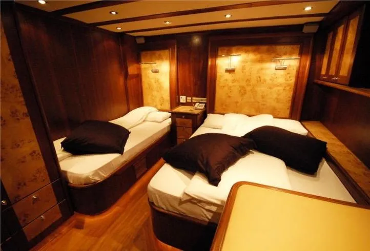 42 M Custom Made Motorsailor Yacht Photos Pics Luxurious cabin interior of 2006 Custom Made 42 M Motorsailor with twin beds and warm lighting.