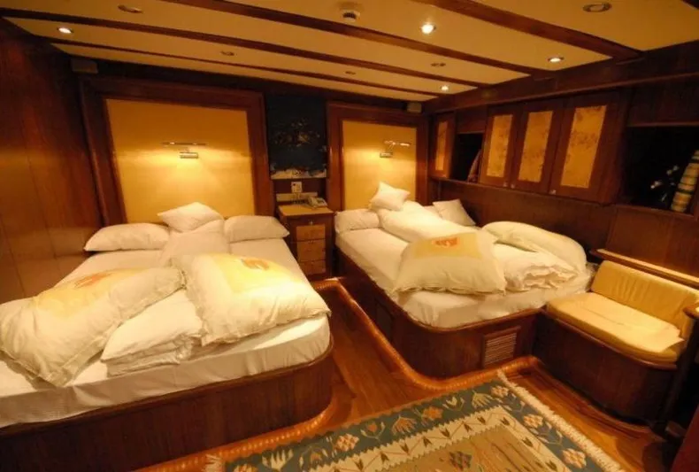 42 M Custom Made Motorsailor Yacht Photos Pics Luxurious cabin interior of 2006 Custom Made 42 M Motorsailor with twin beds and wooden decor.