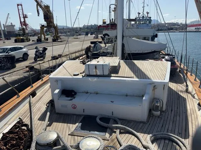 42 M Custom Made Motorsailor Yacht Photos Pics Custom Made 42 M Motorsailor, 2006, docked at a busy harbor with industrial cranes.