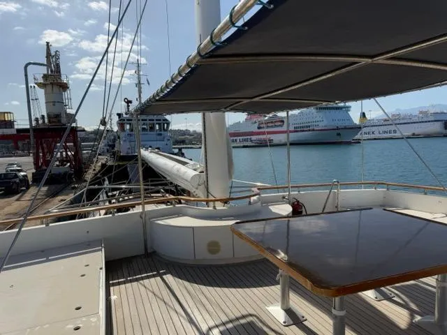 42 M Custom Made Motorsailor Yacht Photos Pics Custom Made 42 M Motorsailor, 2006, docked with shaded deck and table, harbor view.