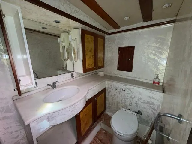 42 M Custom Made Motorsailor Yacht Photos Pics Luxurious bathroom in 2006 Custom Made 42 M Motorsailor with elegant fixtures and wood accents.