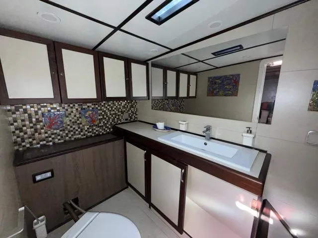 42 M Custom Made Motorsailor Yacht Photos Pics Luxurious bathroom in 2006 Custom Made 42 M Motorsailor with modern fixtures and mosaic backsplash.